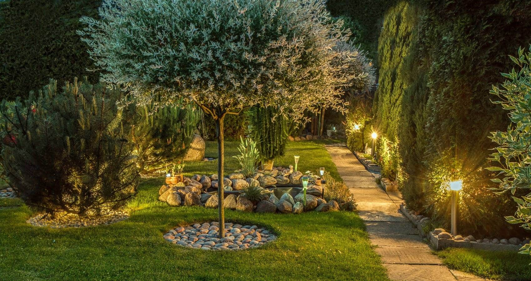lit walking path with private garden at night