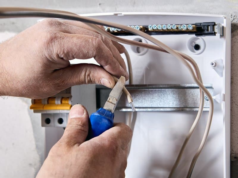 aluminum wiring with a copper-colored wire nut connecting two wires together.