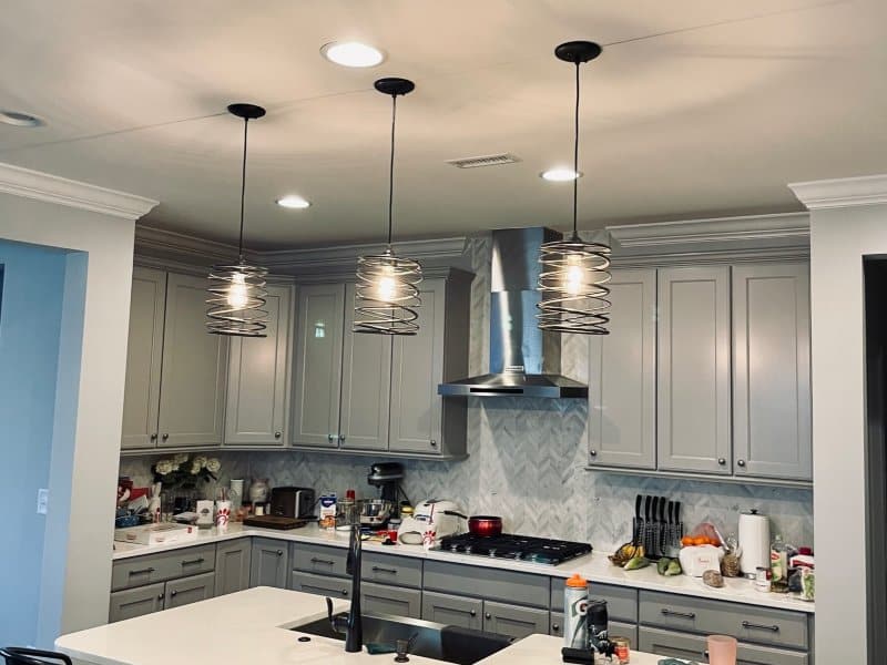 kitchen with gray cabinets and indoor lighting and unique lighting fixtures