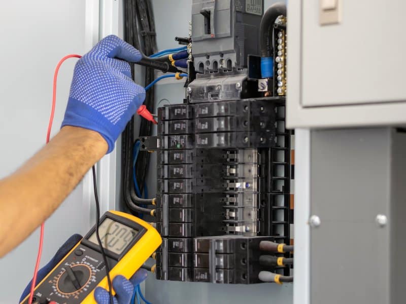 examining a control panel inside a commercial building