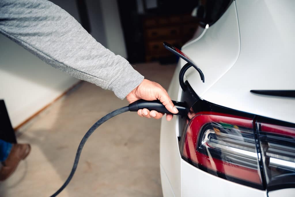 man charging his vehicle